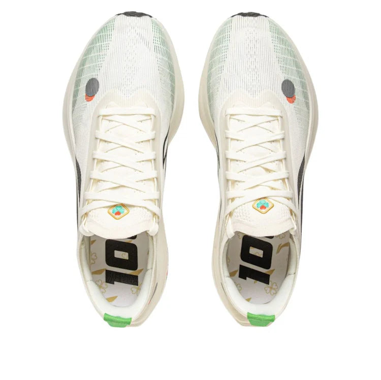 Milky white knit runner with white laces, black heel panel and green accent sole
