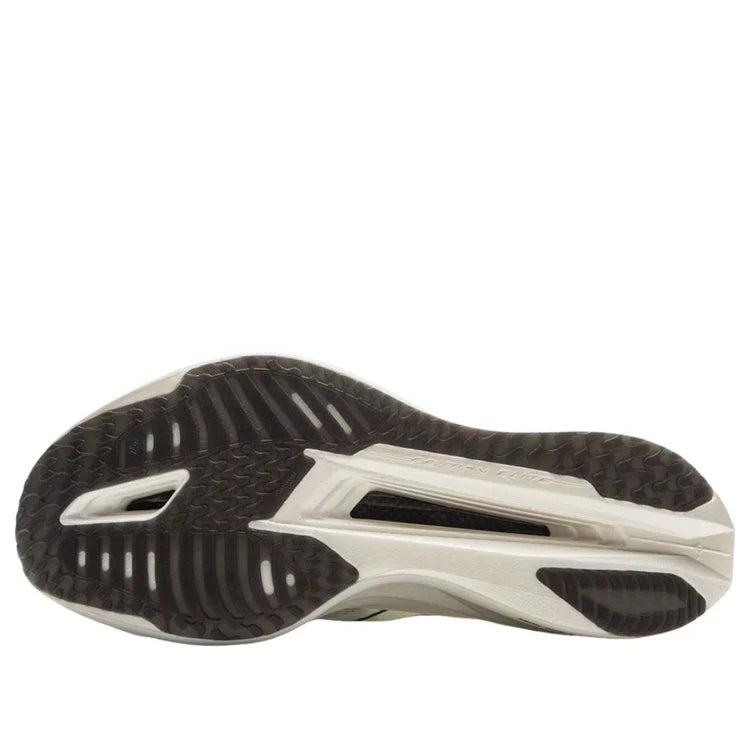 White-and-black rubber outsole with tread and rocker styling