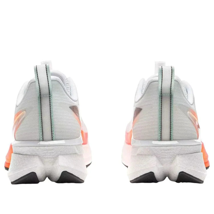 Pair of white running shoes with orange heel accent and light blue heel stripe