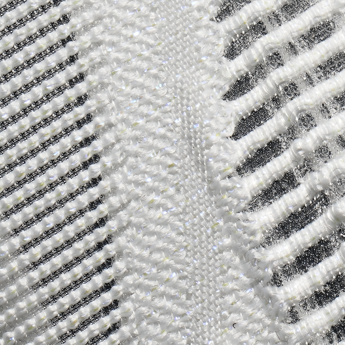 Silver and white knit upper texture with dark stripe detailing