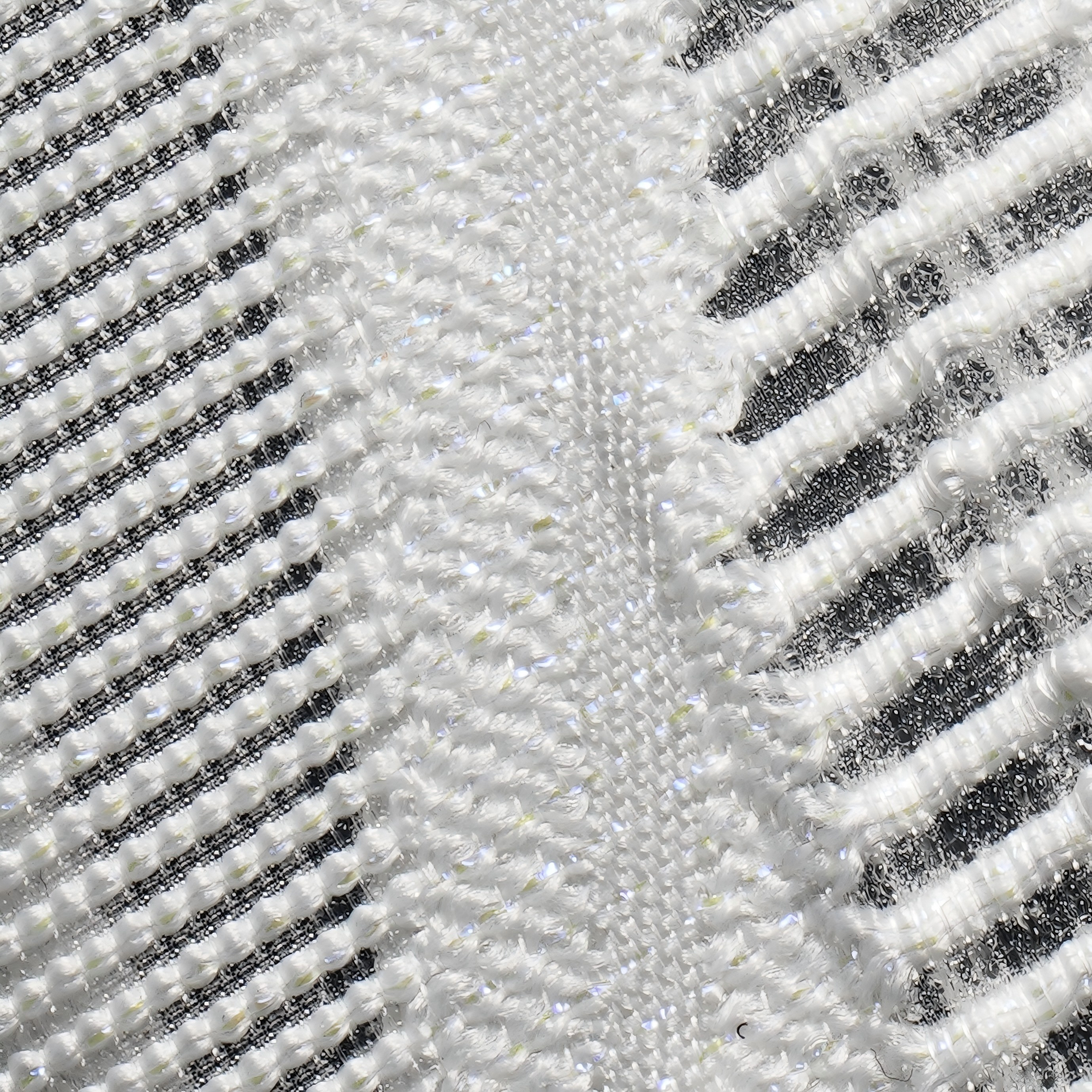 Silver and white knit upper texture with dark stripe detailing