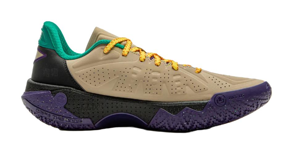 Basketball shoe with beige toe, black midfoot, purple heel panel, green collar, orange laces