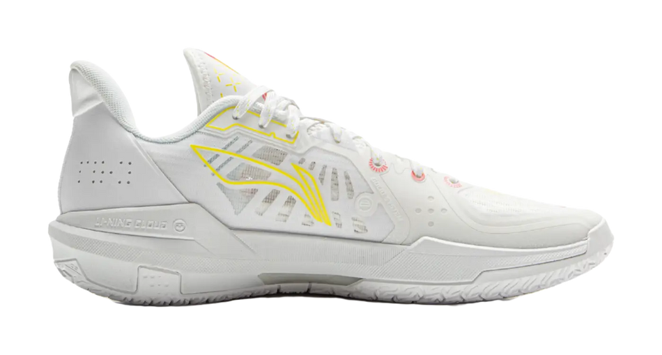 White basketball shoes, side view, yellow trim and pink detailing on upper