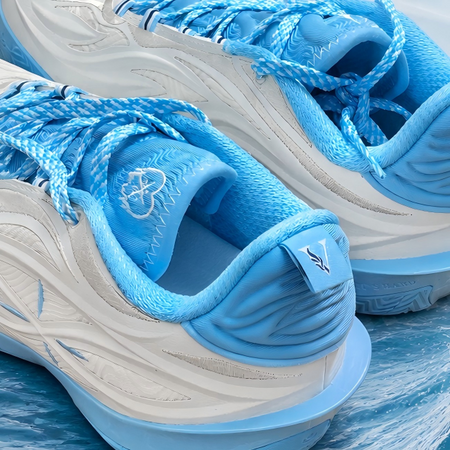 Unisex basketball shoe heel and collar close-up in milky white with light blue lining.