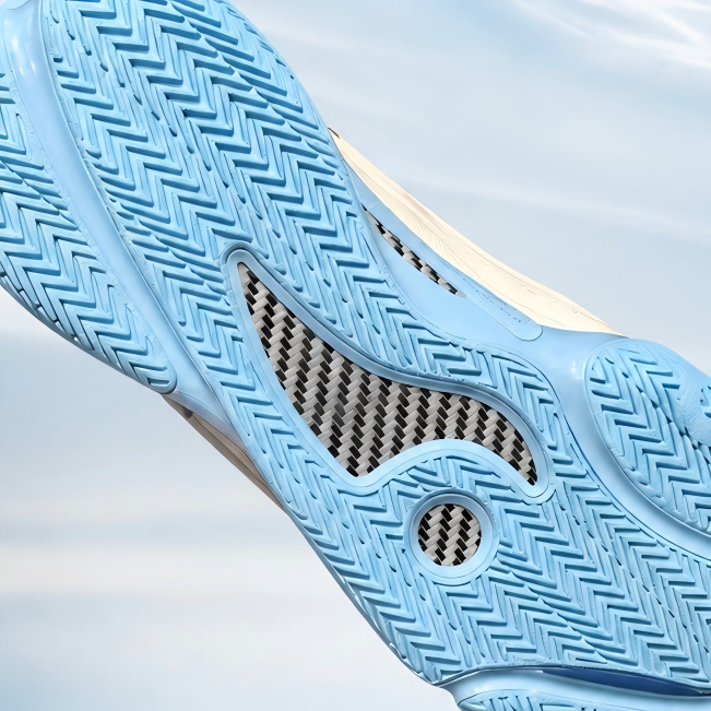 Basketball shoe outsole with light blue traction pattern and circular logo detail