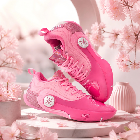 Pink basketball sneaker pair, one side up and one side down with lace-up
