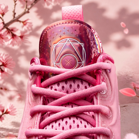 Pink basketball sneaker heel-tongue area with emblem and crisscross laces