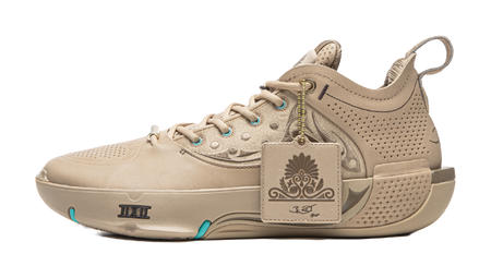 Basketball shoe in tan with teal lace eyelets and side emblem patch detail