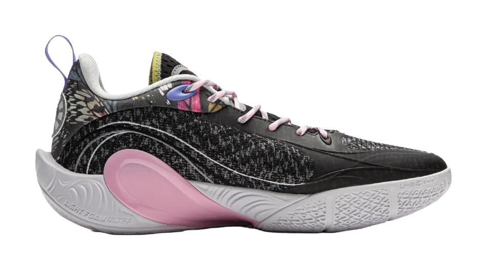 Black low-top basketball shoe with speckled texture, pink heel panel, and white outsole