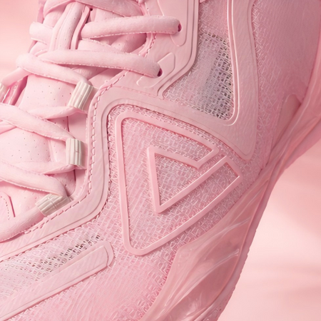 Light pink basketball shoe side close-up with molded triangle logo details