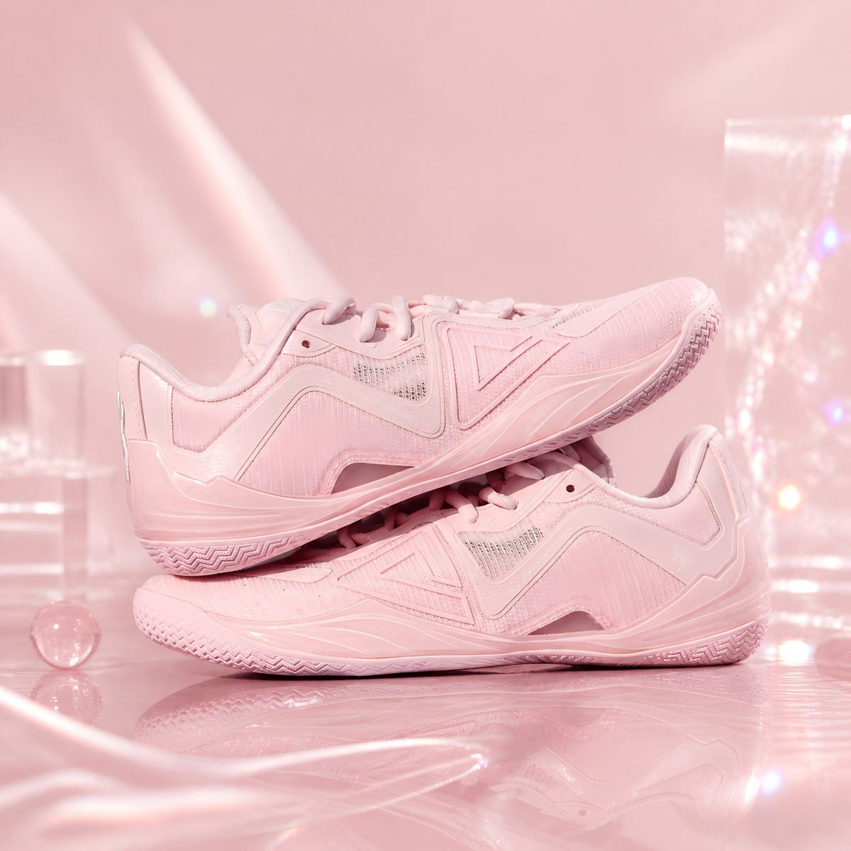 Pair of light pink basketball shoes top side view with lace-up and textured sole