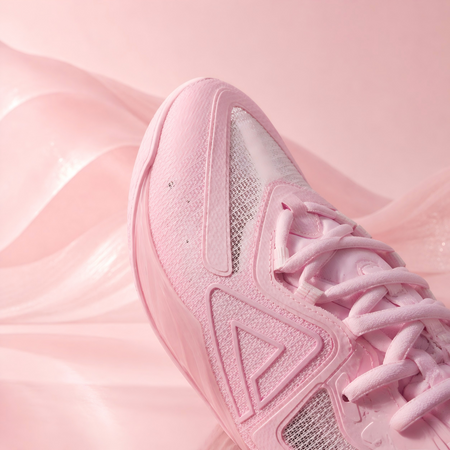 Pink basketball shoe with mesh panel, lace-up front, and side logo detail