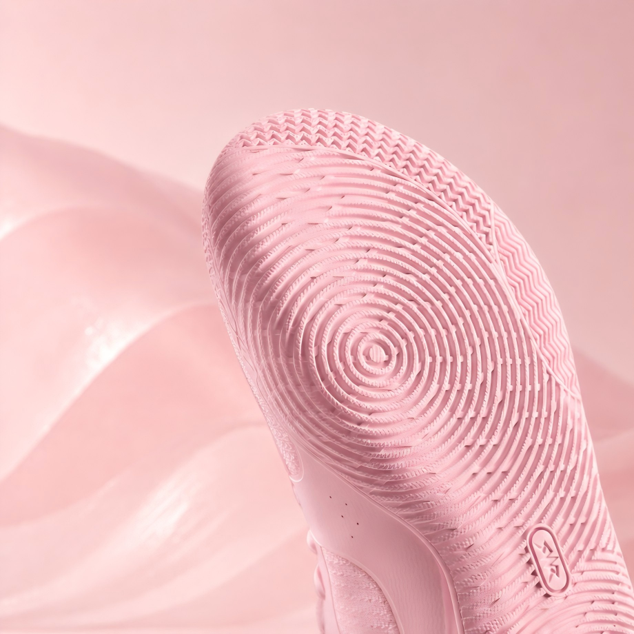 Pink basketball shoe sole with circular tread pattern