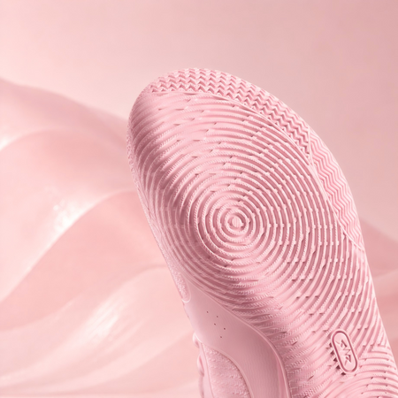 Pink basketball shoe sole with circular tread pattern