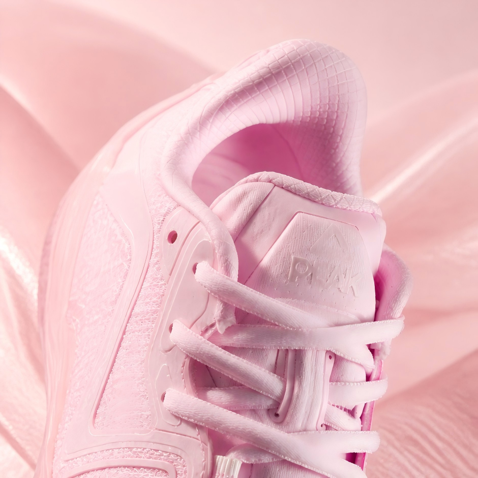 Pink basketball shoe heel and lace-up upper with textured overlay