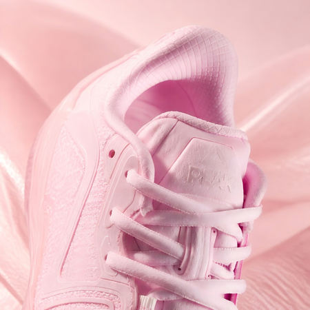 Pink basketball shoe heel and lace-up upper with textured overlay