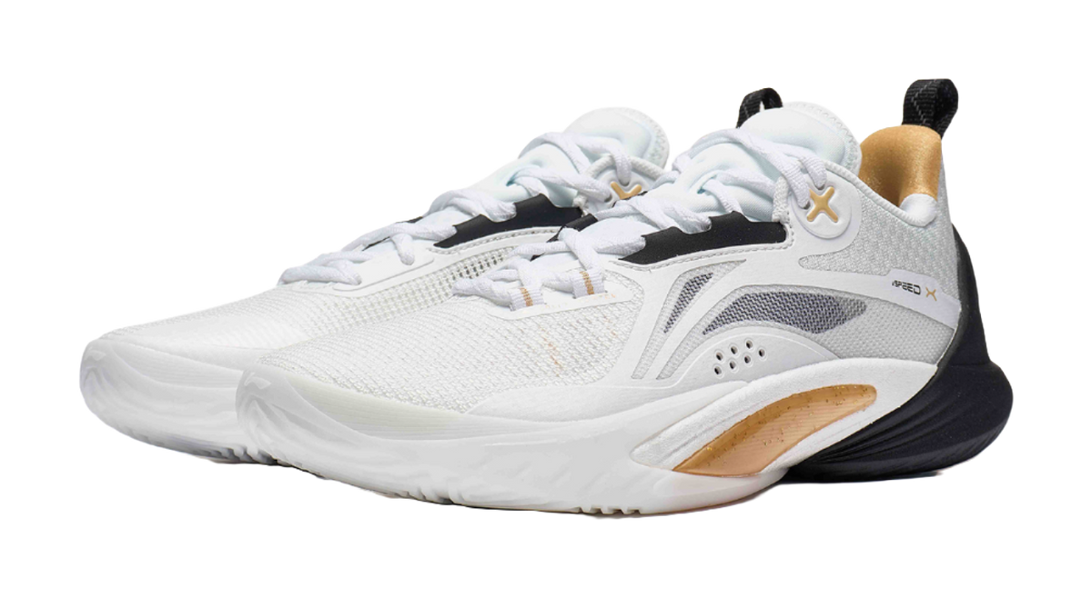 White and black basketball shoe with gold accent around collar, lace-up knit upper