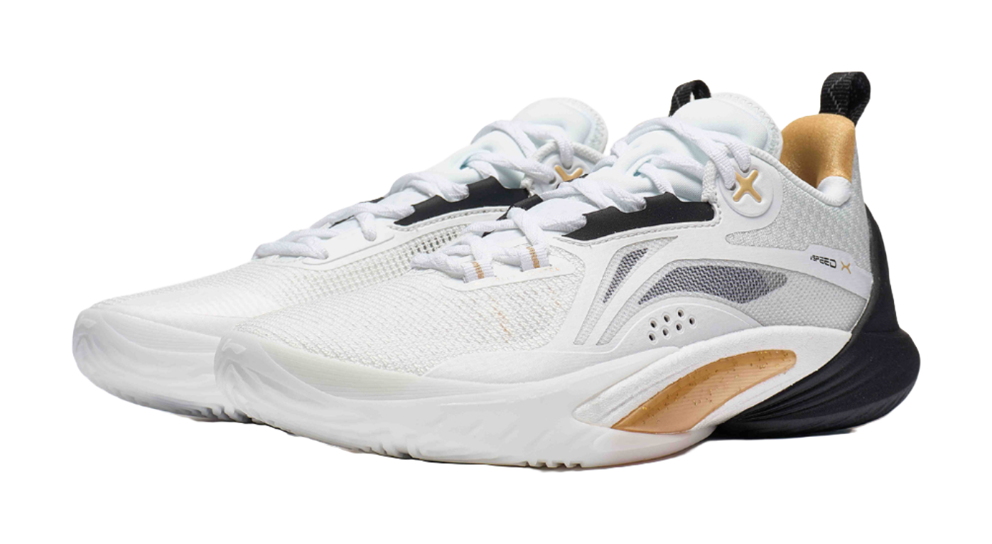 White and black basketball shoe with gold accent around collar, lace-up knit upper
