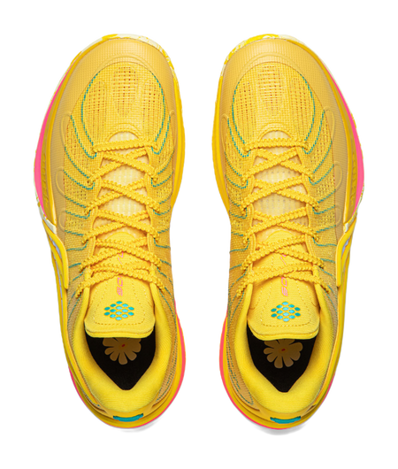 Pair of lemon yellow lace-up basketball shoes with cushioned tongue and flower heel graphic