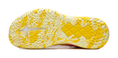 Lemon yellow basketball shoe outsole with textured tread and star-pattern traction pods