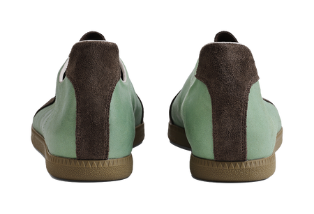 Mint and brown training shoes from heel view with cushioned back panel