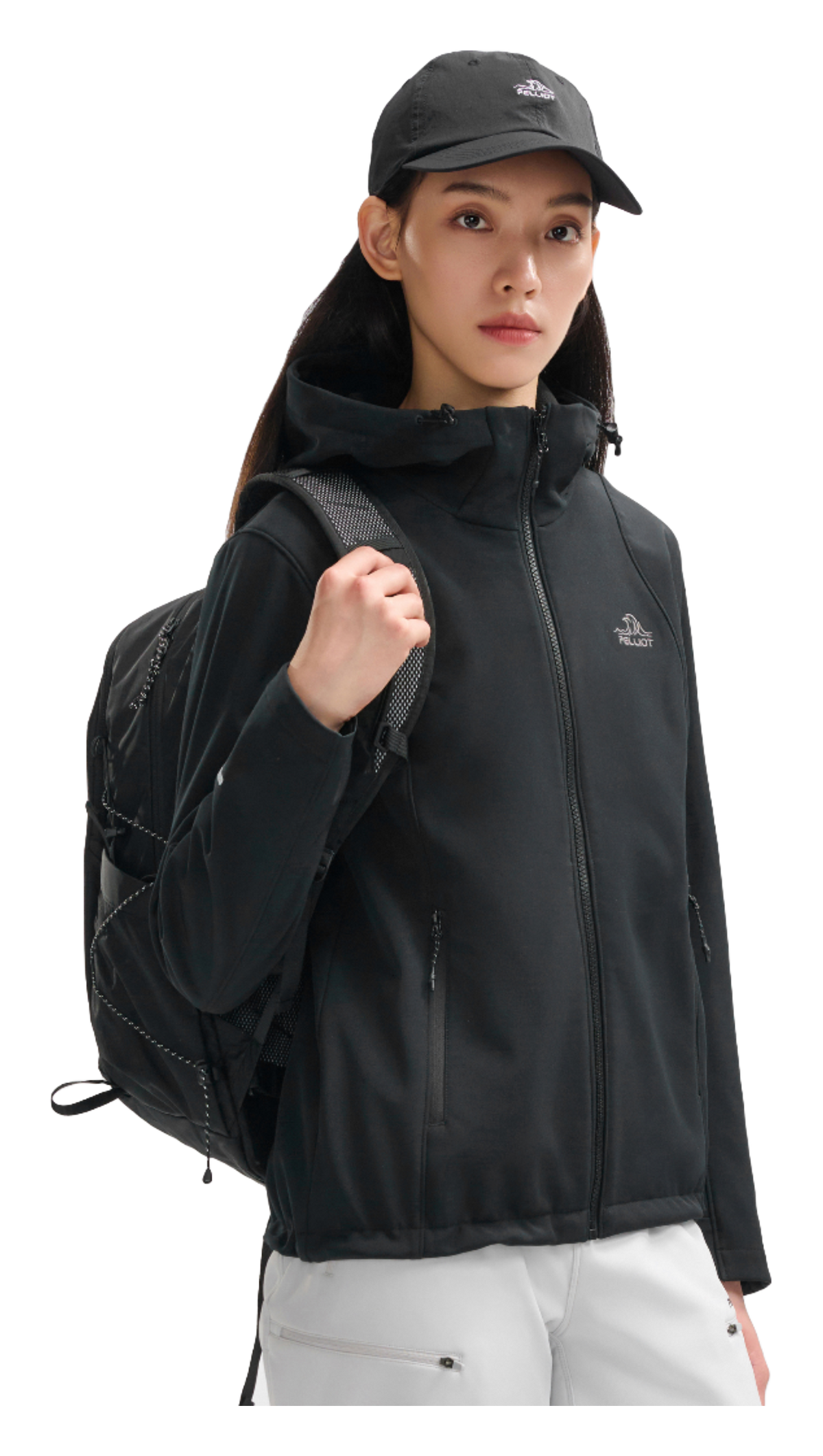 Women’s obsidian black soft shell jacket on model, side view with hood and full-zip front
