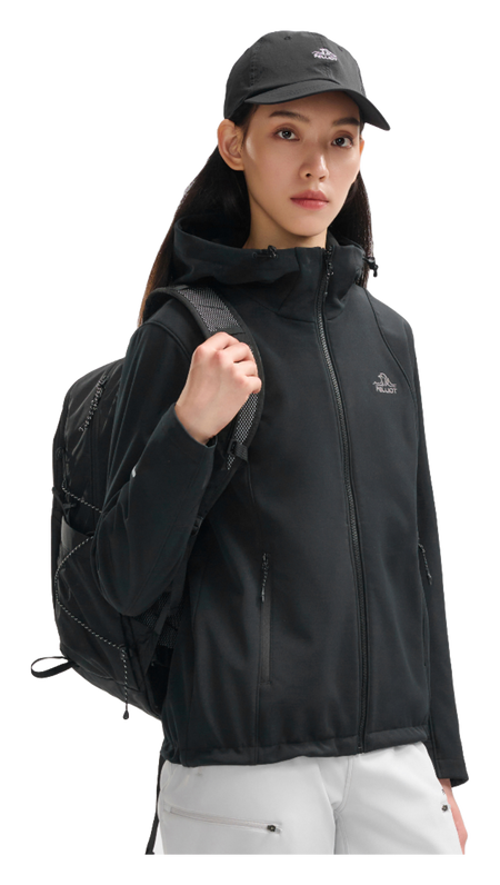 Women’s obsidian black soft shell jacket on model, side view with hood and full-zip front