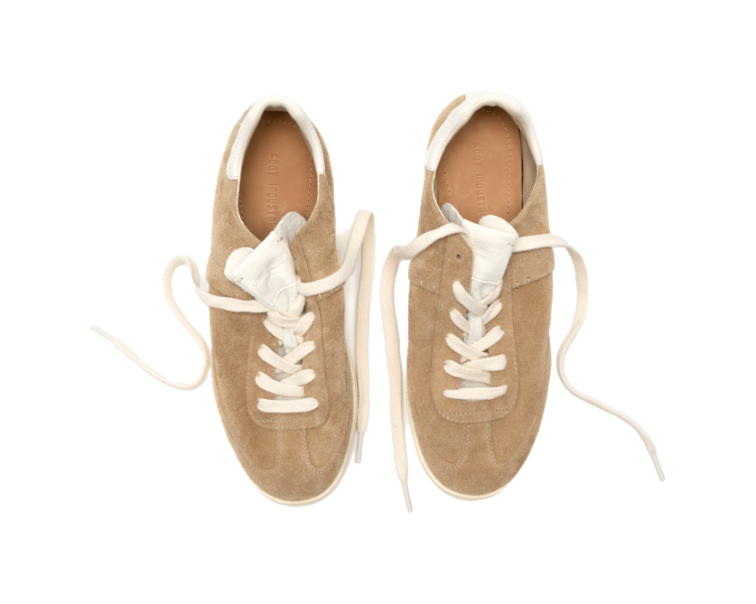 Pair of sand suede low-top skate shoes with white laces and padded white collars