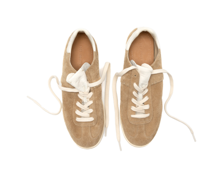 Pair of sand suede low-top skate shoes with white laces and padded white collars