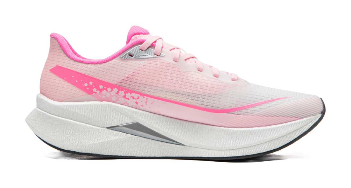 Pink running shoe side view with white laces, gray sole, pink logo and floral accents