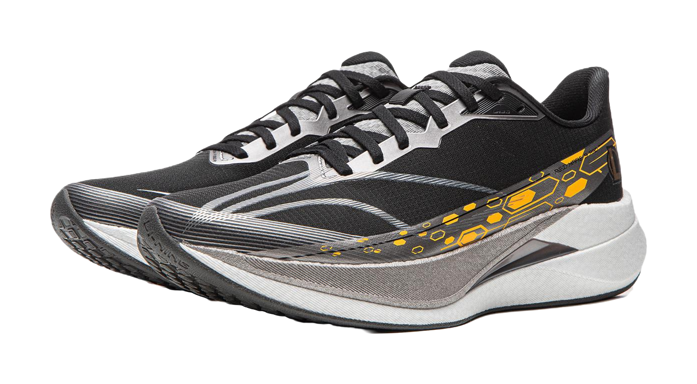 Black running shoe with textured gray panels, white-gray sole and yellow-orange stripe.