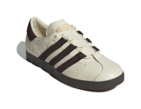 Unisex low-top skate shoes, cream upper with dark brown stripe detail and laces