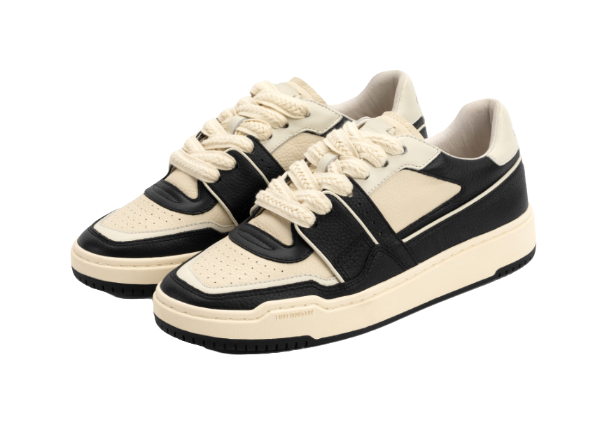 Pair of unisex skate trainer shoes, black uppers with white toe and side panels