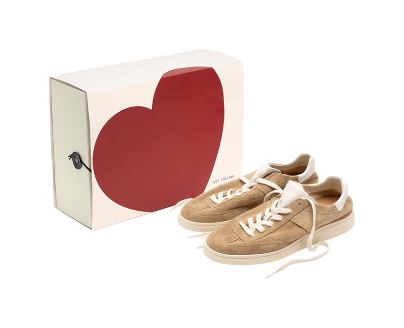 Sand and white low-top skate shoes with white laces, shown with shoe box