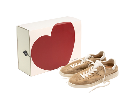 Sand and white low-top skate shoes with white laces, shown with shoe box