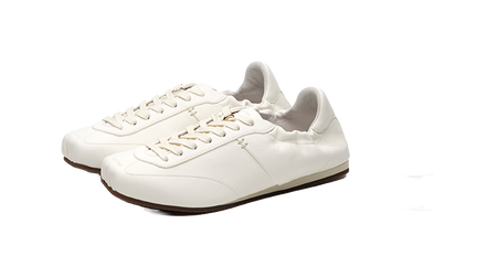 Antique white low-top trainers pair, lace-up front and thin sole with dark edge