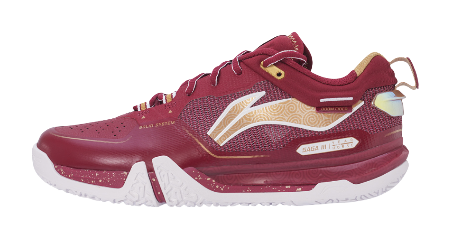 Red badminton shoe with mesh upper, gold accents, white outsole, and lace-up front.