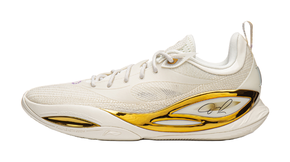 Unisex basketball shoe in light silver/white with gold trim and lace-up design.