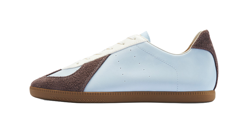 Two-tone low-top leather training shoes with light blue and dark brown panels, gum sole