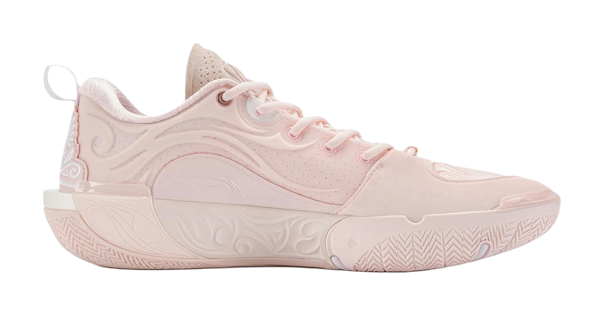 Light pink lace-up basketball shoe with high collar and patterned rubber outsole