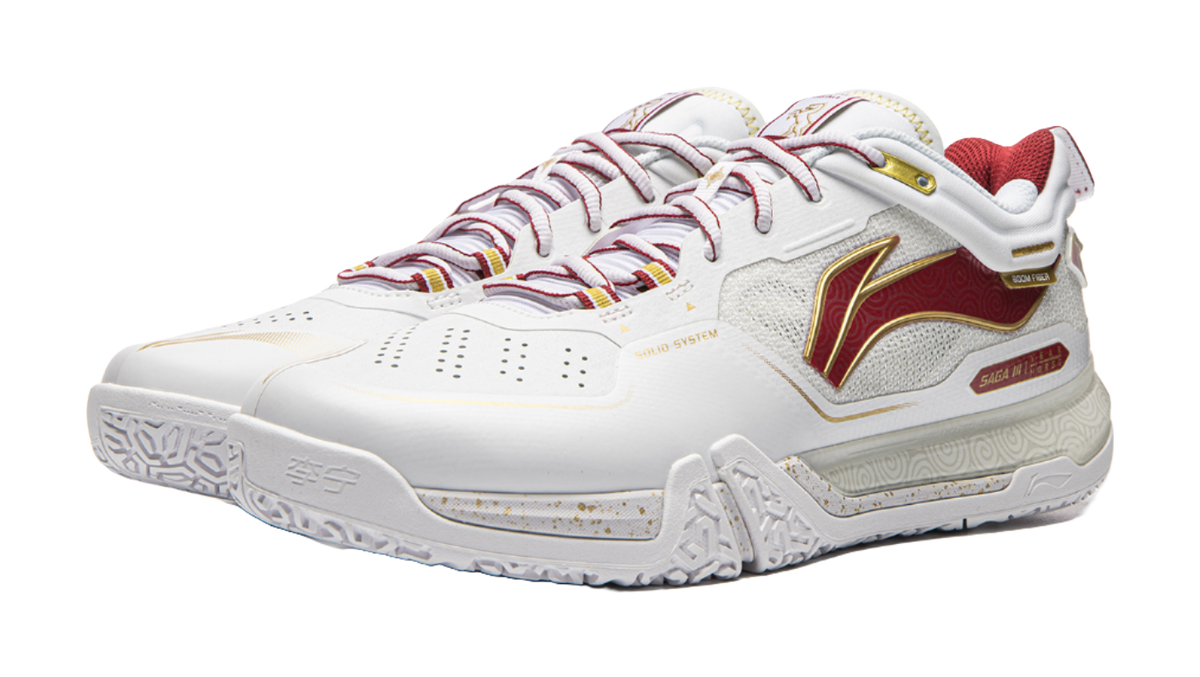 White and red lace-up badminton shoe with decorative side panel and textured sole