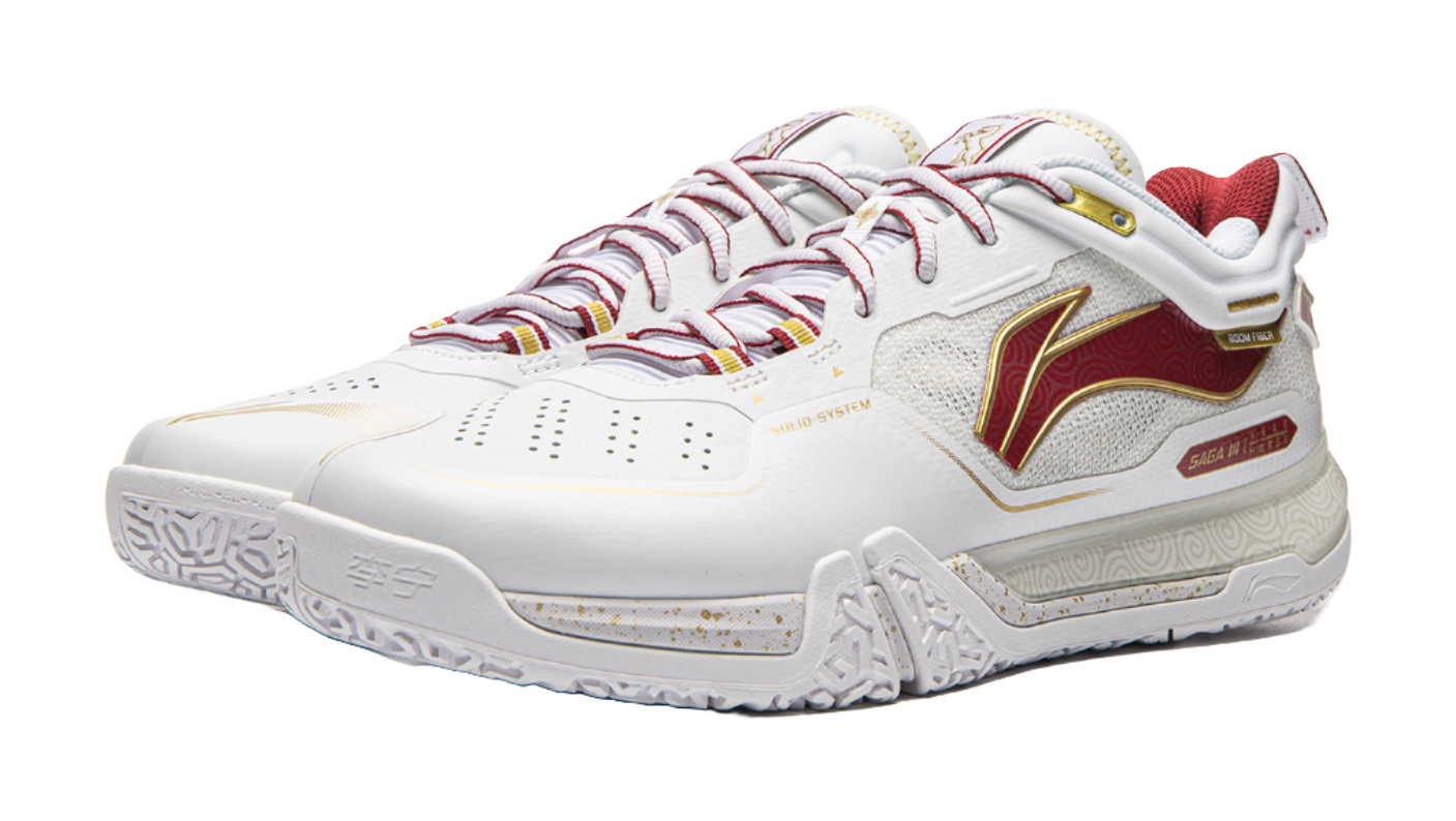 White and red lace-up badminton shoe with decorative side panel and textured sole