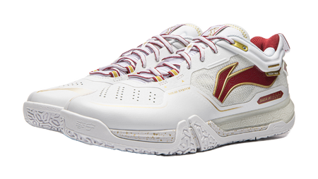 White and red lace-up badminton shoe with decorative side panel and textured sole