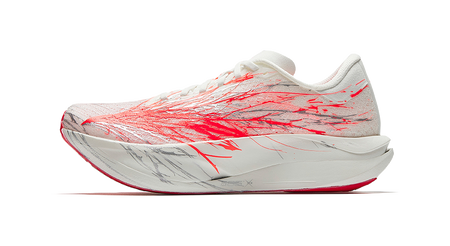 White running shoes with red graphic print, lace-up knit upper, cushioned sole.