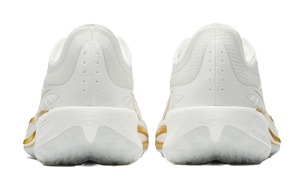 Pair of men's white low-top basketball shoes, rear view with gold heel accents