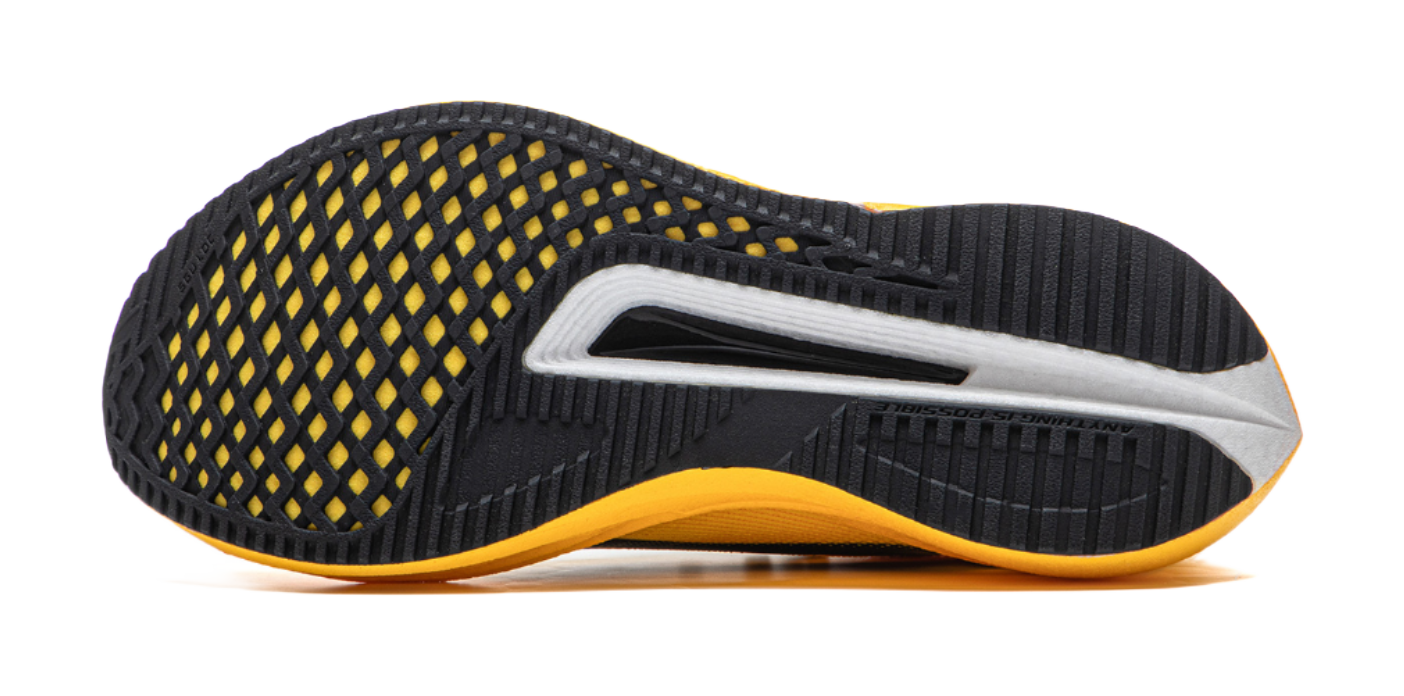 Black and yellow low-top running shoe outsole side view with textured grip pattern.