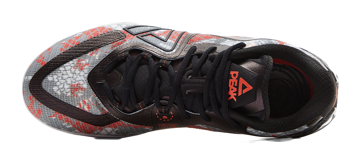 Basketball shoe upper with black lace-up closure and red graphic on tongue