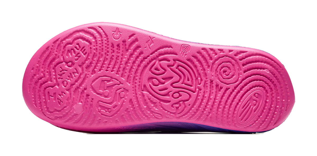 Unisex slide sandal outsole bottom with pink tread pattern and grip circles