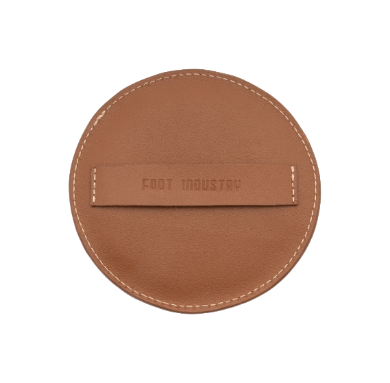 Brown leather label with 'FOOT INDUSTRY' stamped text and stitched edge
