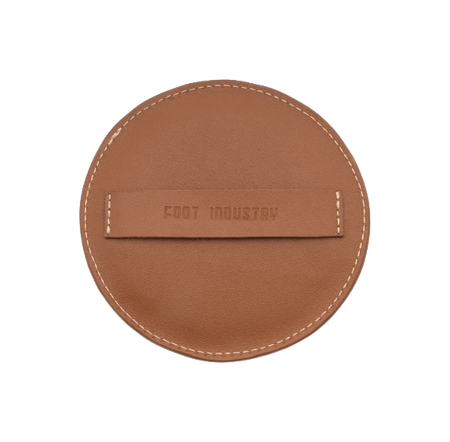 Brown leather label with 'FOOT INDUSTRY' stamped text and stitched edge